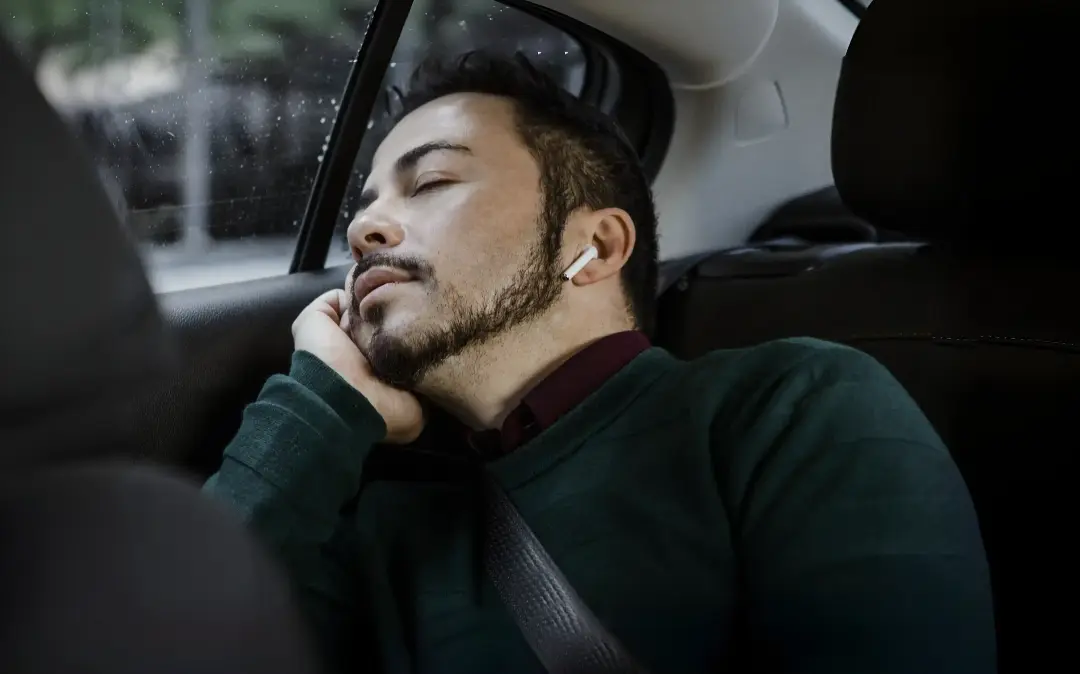 Middle aged man in a trance while listening to a guided hypnosis session from the AuDela mobile app